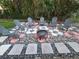 Backyard patio featuring a fire pit surrounded by comfortable Adirondack chairs at 663 68Th S Ave, St Petersburg, FL 33705