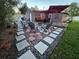 Cozy backyard patio with a fire pit, comfortable seating, and a decorative stone design at 663 68Th S Ave, St Petersburg, FL 33705