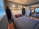 Bedroom featuring tiled floor, neutral walls, ceiling fan, one window and mirrored closet at 663 68Th S Ave, St Petersburg, FL 33705