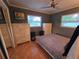 Bedroom featuring tiled floor, neutral walls, ceiling fan, two windows and closet at 663 68Th S Ave, St Petersburg, FL 33705