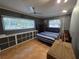 Bedroom featuring tiled floor, neutral walls, ceiling fan, storage and sun filled window at 663 68Th S Ave, St Petersburg, FL 33705