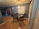 Cozy dining area with a glass table, four wrought iron chairs, and neutral decor at 663 68Th S Ave, St Petersburg, FL 33705