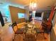 Dining area with a round glass table and views into other rooms at 663 68Th S Ave, St Petersburg, FL 33705