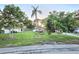 Cozy home with mature trees, a verdant lawn, and basic landscape at 663 68Th S Ave, St Petersburg, FL 33705