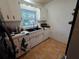 Kitchen sink with white cabinets, black countertops, and a window at 663 68Th S Ave, St Petersburg, FL 33705
