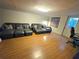 Living room with laminate flooring, two large sofas, and a door to the backyard at 663 68Th S Ave, St Petersburg, FL 33705