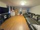 Spacious living room featuring laminate flooring and a large sofa at 663 68Th S Ave, St Petersburg, FL 33705
