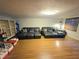 Living room with laminate flooring, two large sofas, and a window with blinds at 663 68Th S Ave, St Petersburg, FL 33705