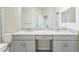 Bathroom featuring double sinks with a granite countertop and light gray cabinets at 8126 Muddy Pines Pl, Tampa, FL 33635