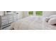 Bright bedroom features a dresser, mirror, and a plush bed offering a relaxing retreat at 8126 Muddy Pines Pl, Tampa, FL 33635