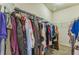 Walk-in closet with ample storage and organization space with hanging clothes at 8126 Muddy Pines Pl, Tampa, FL 33635