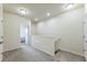 Upstairs hallway with neutral walls, carpet flooring, and doors leading to bedrooms at 8126 Muddy Pines Pl, Tampa, FL 33635