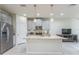 Modern kitchen with stainless steel appliances, granite countertops, and a large center island at 8126 Muddy Pines Pl, Tampa, FL 33635