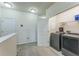 Upstairs laundry area offers convenience with modern appliances and storage shelves at 8126 Muddy Pines Pl, Tampa, FL 33635