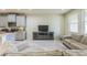 Cozy living area featuring comfortable seating, a media center, and a bright sunny window at 8126 Muddy Pines Pl, Tampa, FL 33635