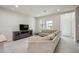 Bright living room featuring comfortable furniture, natural light, and a modern entertainment center at 8126 Muddy Pines Pl, Tampa, FL 33635