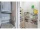 Organized pantry with wire shelves, offering ample storage space with granite counter space nearby at 8126 Muddy Pines Pl, Tampa, FL 33635
