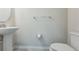 This powder room features a pedestal sink, toilet, towel bar, and minimalist design at 8126 Muddy Pines Pl, Tampa, FL 33635