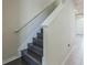 Dark hardwood staircase ascends to the next level with white walls at 8126 Muddy Pines Pl, Tampa, FL 33635