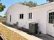 View of the home's exterior featuring an AC unit and back door at 7342 Skyview Ave, New Port Richey, FL 34653