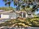 Charming single-story home featuring a well-manicured lawn, classic white exterior, and an inviting arched entryway at 7342 Skyview Ave, New Port Richey, FL 34653