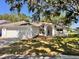 Charming single-story home featuring a well-manicured lawn, classic white exterior, and an inviting arched entryway at 7342 Skyview Ave, New Port Richey, FL 34653