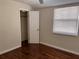 This bedroom has hardwood floors, a window, and a closet at 1834 28Th N Ave, St Petersburg, FL 33713