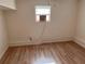 Small bedroom with light-colored walls, laminated floors and an air conditioning unit at 1834 28Th N Ave, St Petersburg, FL 33713