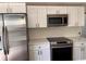 Modern kitchen featuring stainless steel appliances and sleek white cabinetry at 1834 28Th N Ave, St Petersburg, FL 33713
