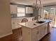 This kitchen features an island with sink, white cabinets, and stainless steel appliances at 1834 28Th N Ave, St Petersburg, FL 33713