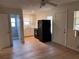 Open living space showing the bathroom, kitchen, and entry door of the home at 1834 28Th N Ave, St Petersburg, FL 33713
