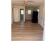 Open living space showing the bathroom, kitchen, and entry door of the home at 1834 28Th N Ave, St Petersburg, FL 33713