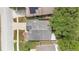 An overhead shot shows the house has a driveway and gray roof, with some lawn area and surrounding trees at 22802 Roderick Dr, Land O Lakes, FL 34639