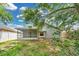 Backyard includes screened-in porch, mature shade trees, and space for outdoor activities at 22802 Roderick Dr, Land O Lakes, FL 34639