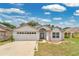 Charming single-story home featuring an attached two-car garage and neutral-toned stucco exterior at 22802 Roderick Dr, Land O Lakes, FL 34639