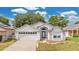 Charming single-story home with attached two-car garage, well-manicured lawn, and traditional landscaping at 22802 Roderick Dr, Land O Lakes, FL 34639