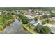 Scenic aerial view of the lake surrounded by homes and lush green trees offering privacy at 22802 Roderick Dr, Land O Lakes, FL 34639