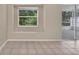 View from living room showcasing tiled flooring, natural light, and access to a screened lanai at 22802 Roderick Dr, Land O Lakes, FL 34639