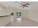 Open living space with tiled flooring, a ceiling fan, and sliding glass doors leading to a lanai at 22802 Roderick Dr, Land O Lakes, FL 34639