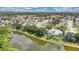An aerial view of the lake surrounding the neighborhood with lush trees at 22802 Roderick Dr, Land O Lakes, FL 34639