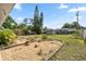 Backyard featuring a shed, tropical plants, and stone-lined garden beds, creating a private retreat at 9033 3Rd N St, St Petersburg, FL 33702