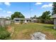 Grassy backyard and gray home exterior at 9033 3Rd N St, St Petersburg, FL 33702