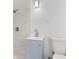 Bathroom features a shower, toilet, and light blue vanity with white countertop at 9033 3Rd N St, St Petersburg, FL 33702
