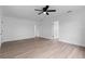 Spacious bedroom featuring sleek laminate flooring, ceiling fan and fresh paint, awaiting personal touches at 9033 3Rd N St, St Petersburg, FL 33702