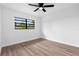 Bright bedroom features wood-look flooring and a ceiling fan at 9033 3Rd N St, St Petersburg, FL 33702