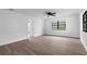 Bright, airy bedroom features a modern ceiling fan, freshly painted walls, and wood-look laminate flooring at 9033 3Rd N St, St Petersburg, FL 33702