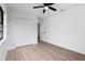 Bright bedroom with new laminate flooring, fresh paint, a modern ceiling fan, and a spacious closet at 9033 3Rd N St, St Petersburg, FL 33702