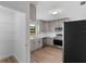 Updated kitchen features stainless steel appliances, modern cabinets, and pantry storage at 9033 3Rd N St, St Petersburg, FL 33702