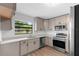 Bright kitchen with white countertops, subway tile backsplash, and stainless steel appliances at 9033 3Rd N St, St Petersburg, FL 33702