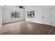 Bright living room showcases new laminate floors, fresh paint, and abundant natural light from large windows at 9033 3Rd N St, St Petersburg, FL 33702